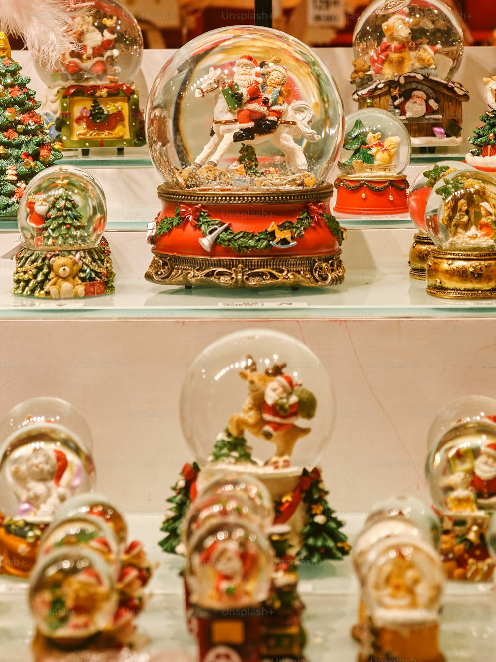 a collection of christmas snow globes on display
