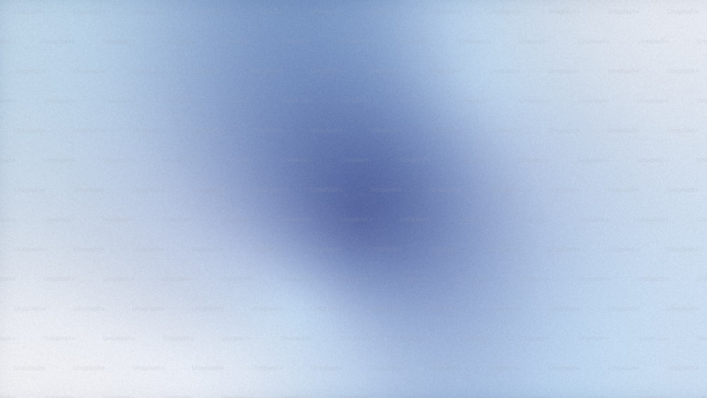 a blurry image of a light blue background