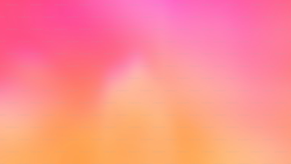a blurry image of a pink and orange background