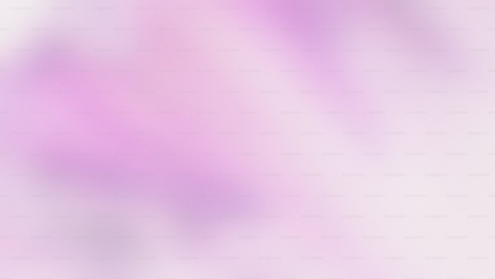 a blurry image of a pink and white background