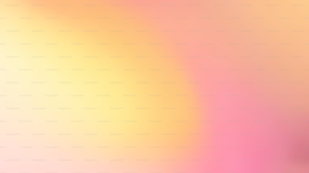 a blurry image of a pink and yellow background