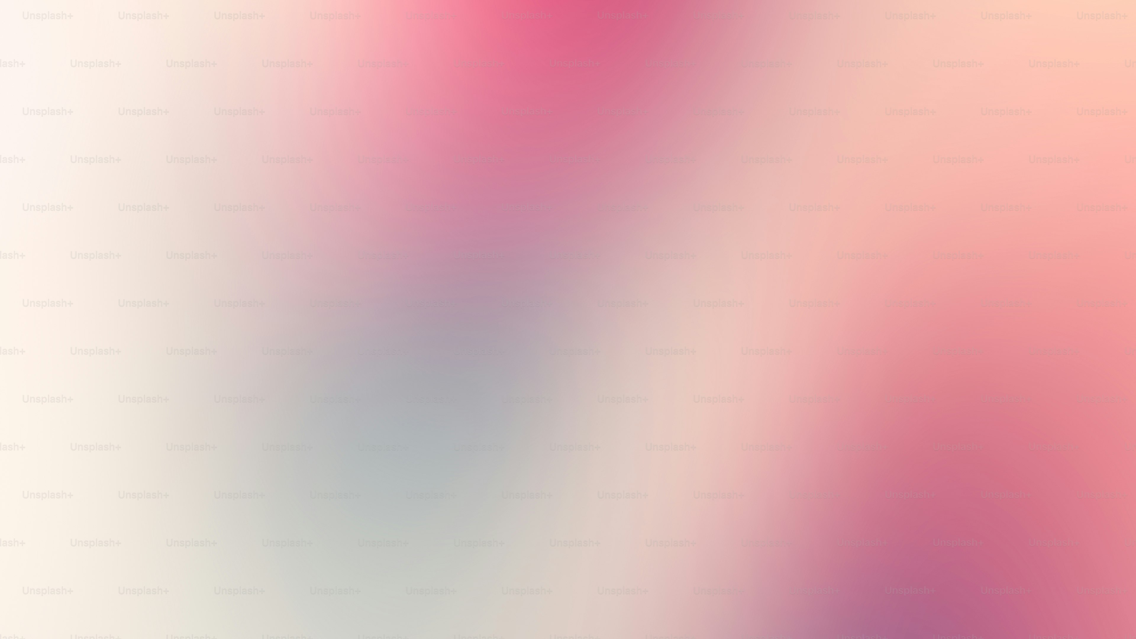 ein verschwommenes Bild mit einem rosa-weißen Hintergrund