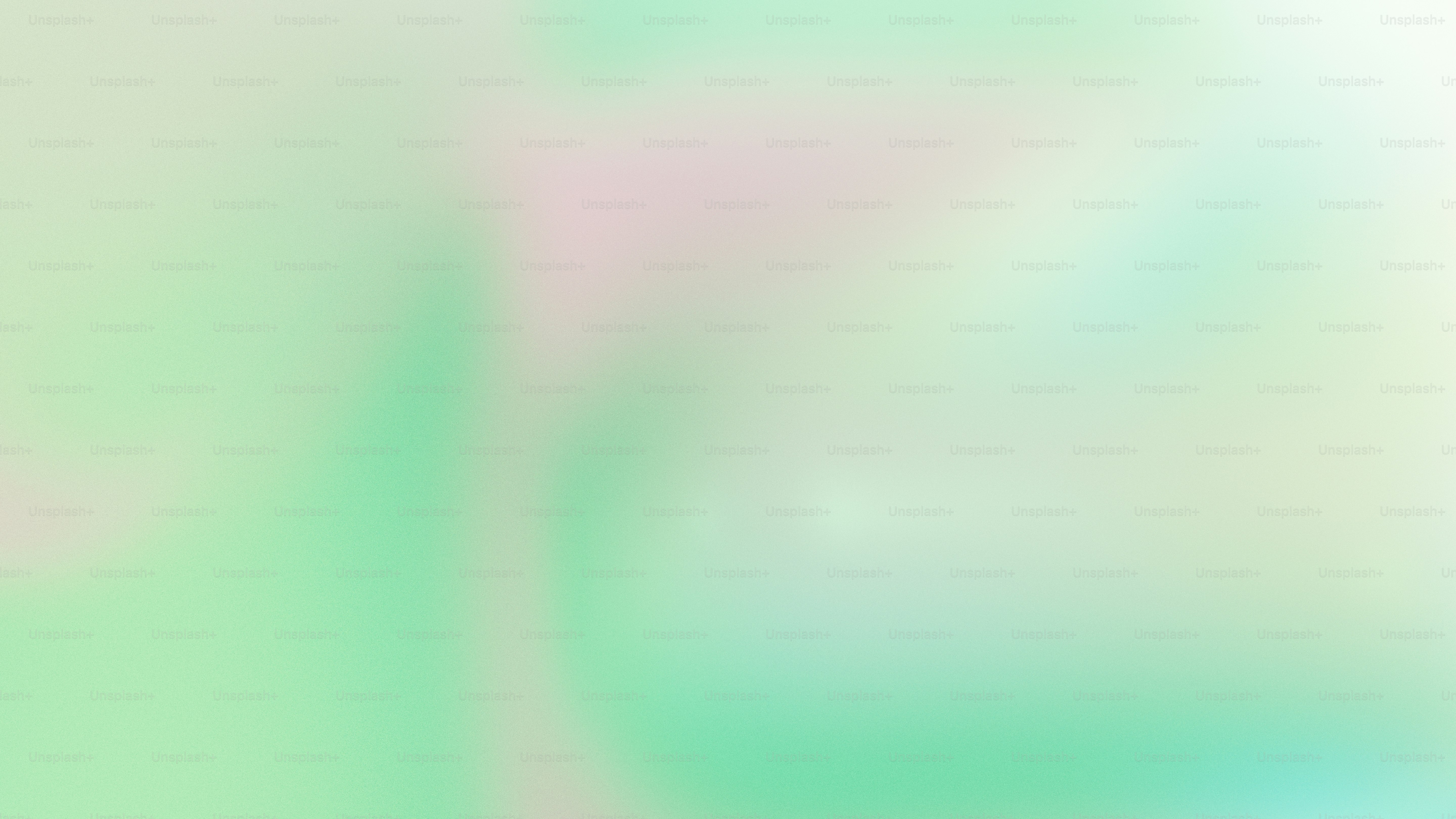 a blurry image of a green and pink background