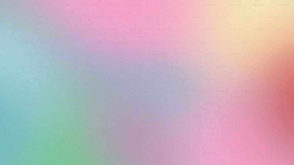a blurry image of a pink, blue, and green background