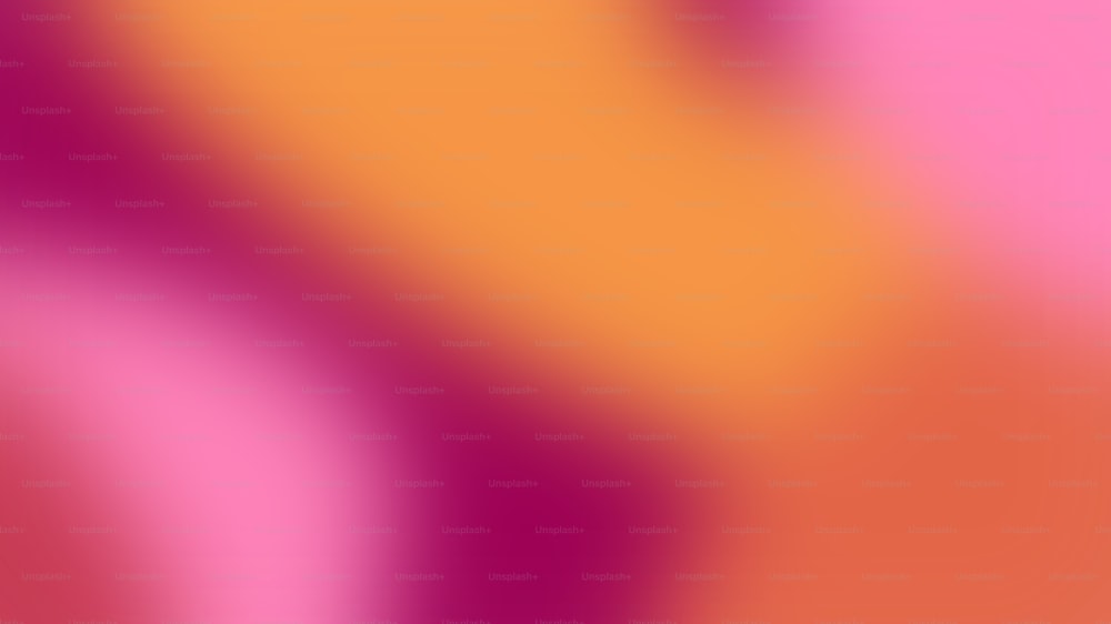 a blurry image of a pink and orange background