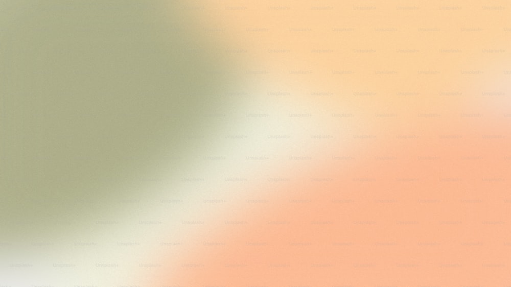 a blurry image of an orange and green background