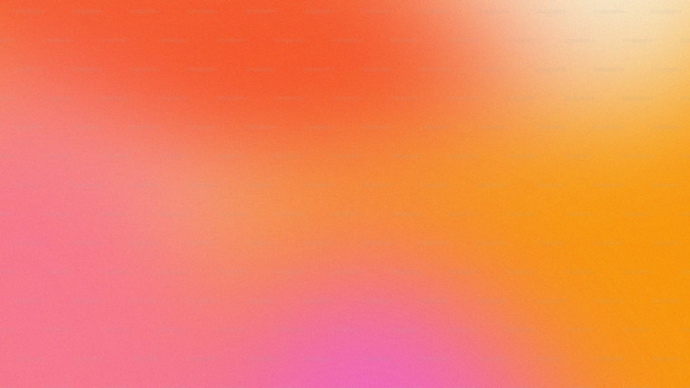 a blurry image of an orange and pink background