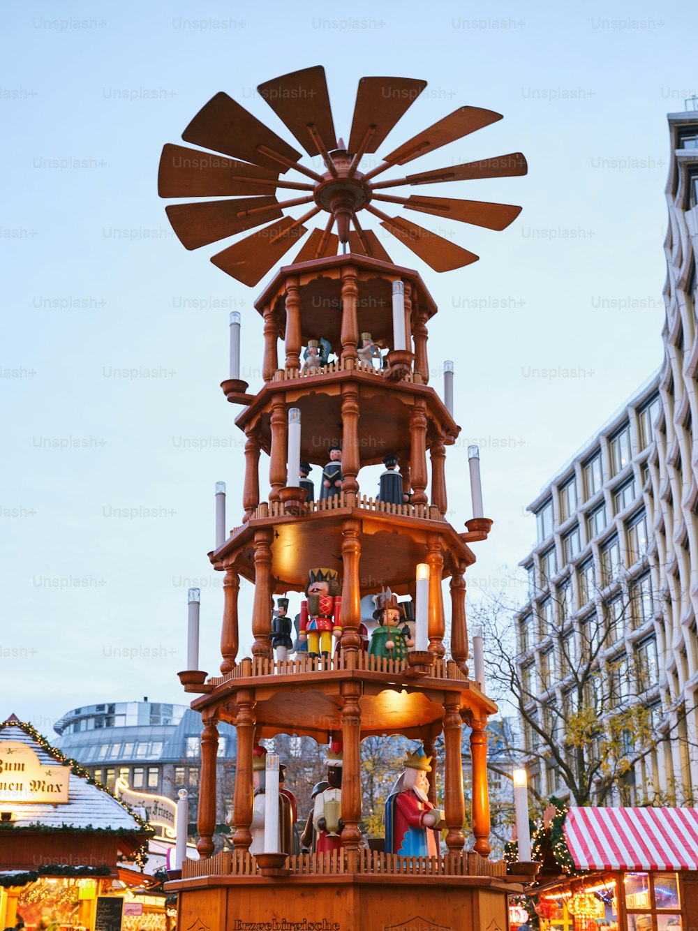 uma grande torre de relógio de madeira com velas em cima dela