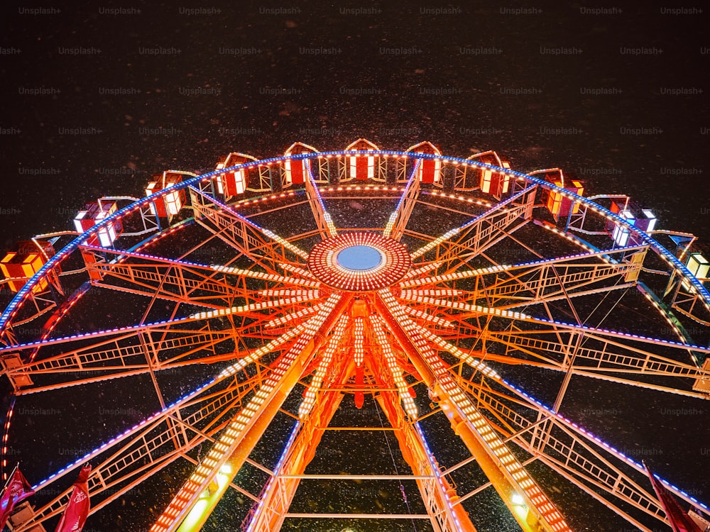 a large ferris wheel lit up at night