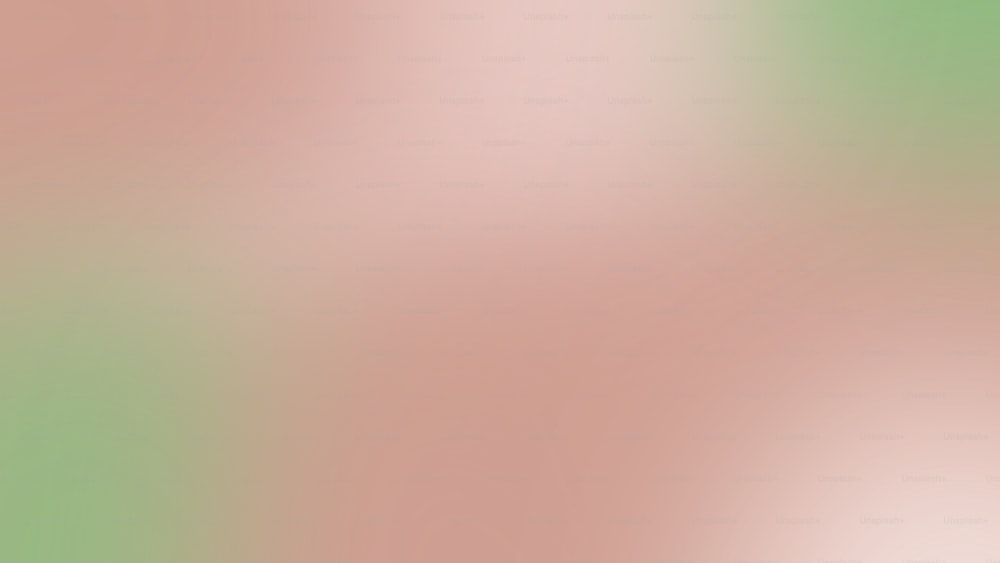 a blurry image of a green and pink background