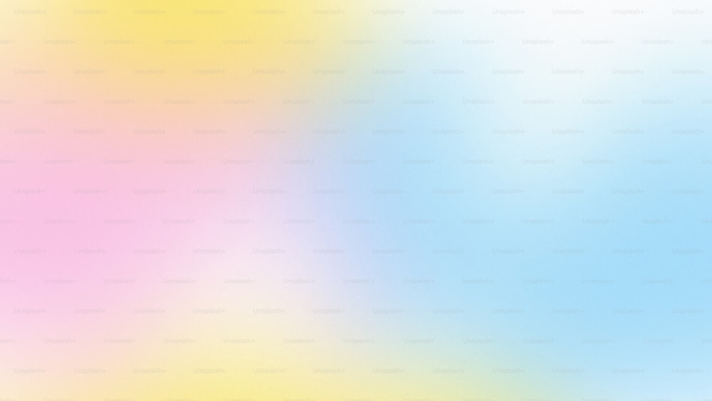 a blurry image of a blue, yellow, and pink background
