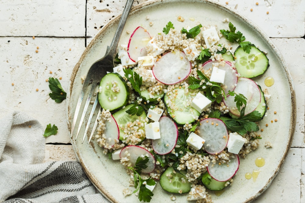 a white plate topped with cucumber and radishes