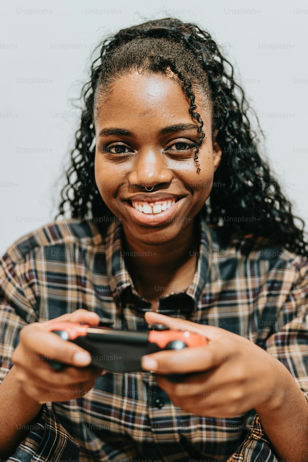 a woman smiles while holding a cell phone