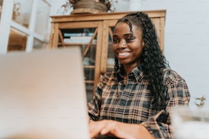 a woman sitting in front of a laptop computer