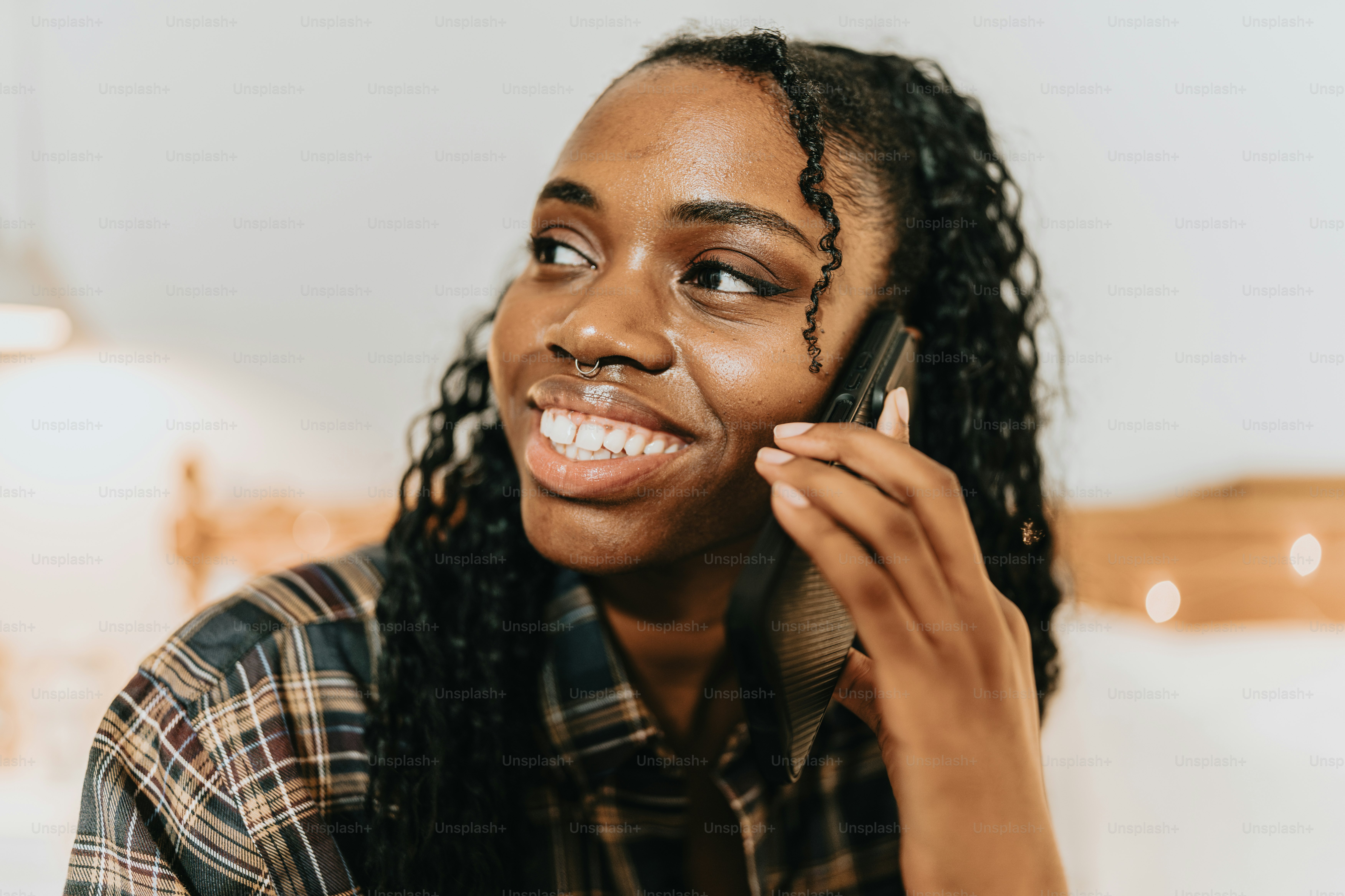 a woman talking on a cell phone with a smile on her face