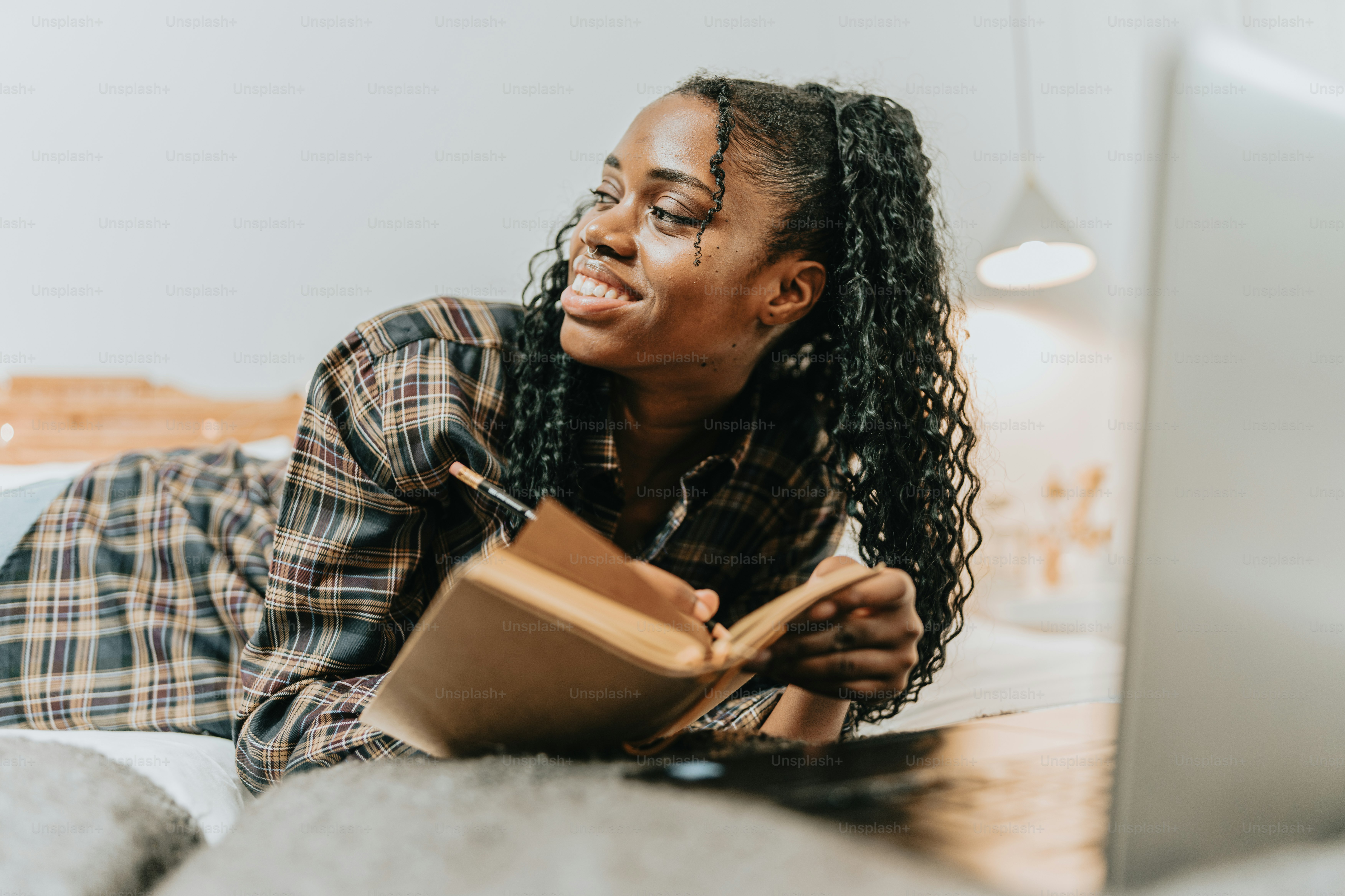 a woman laying on the floor reading a book