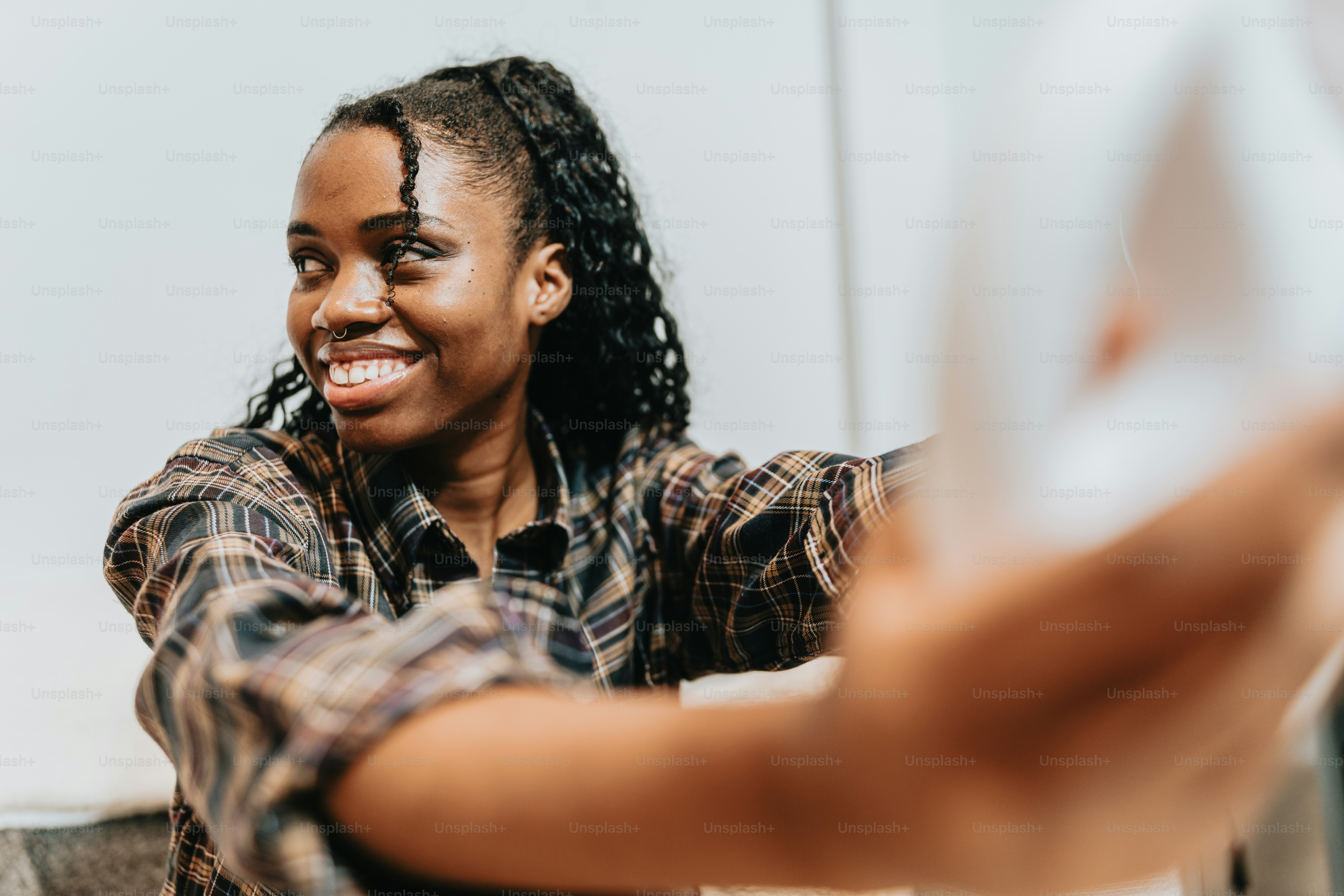 a woman smiles as she sits at a table