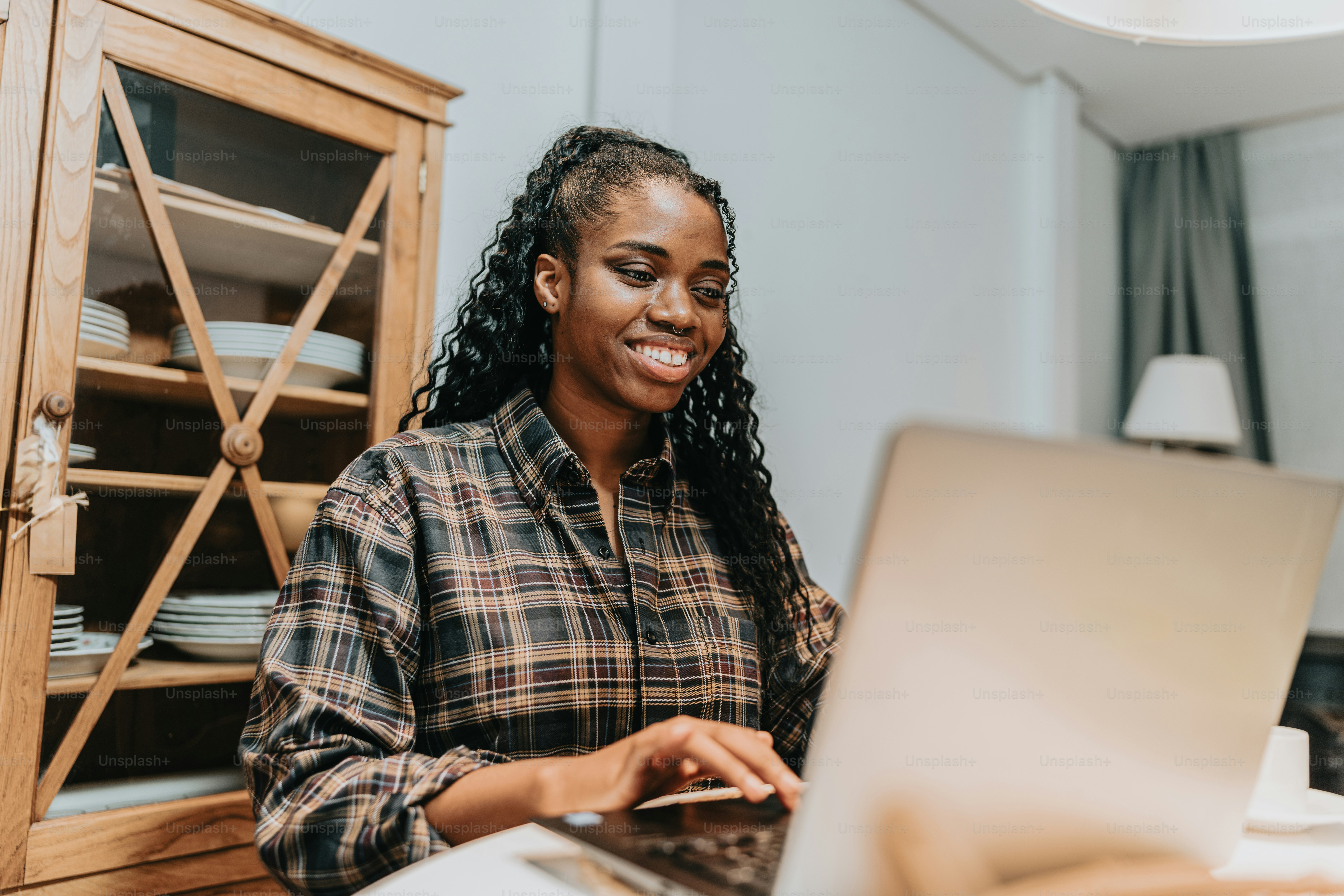 a woman sitting in front of a laptop computer