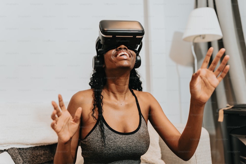 a woman sitting on a couch wearing a virtual reality headset