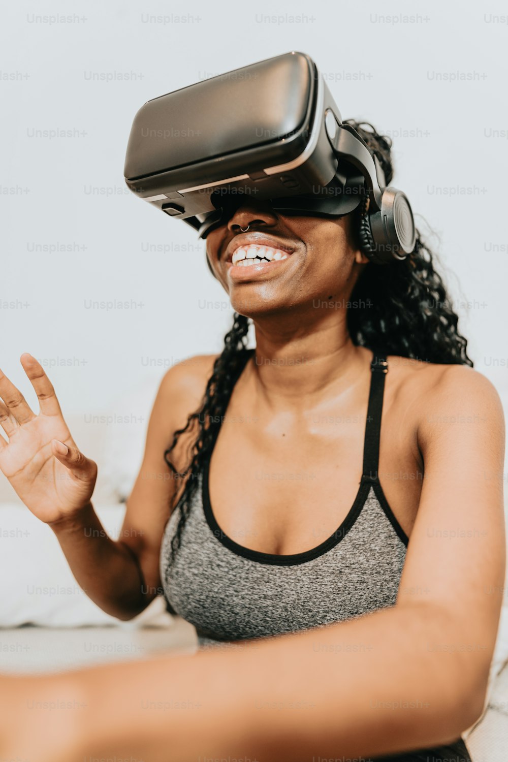 a woman wearing a virtual headset sitting on a couch