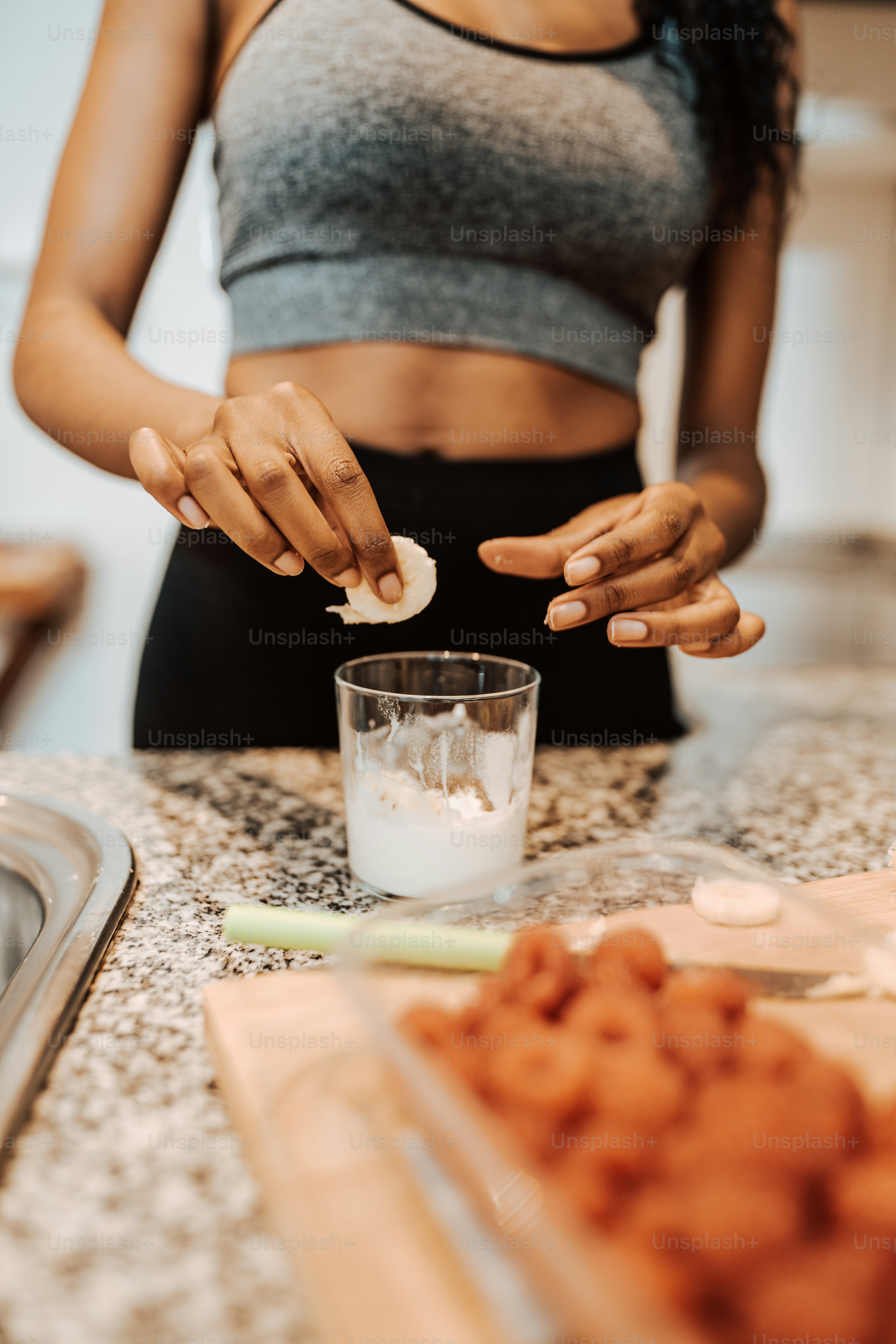 a woman standing in a kitchen preparing food