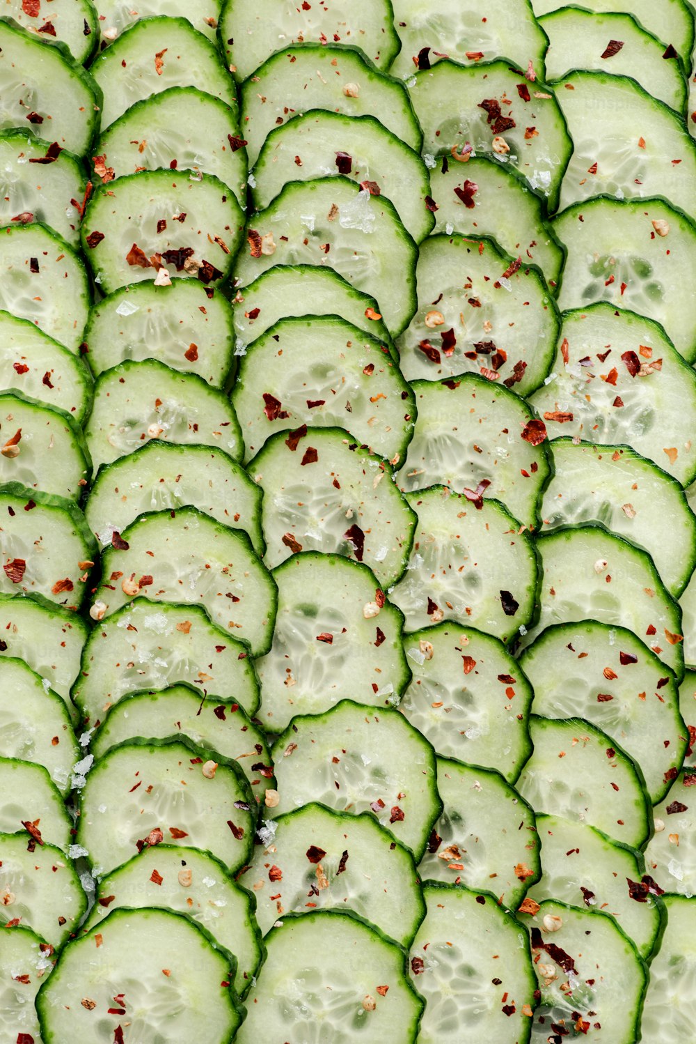 a close up of a tray of cucumber slices