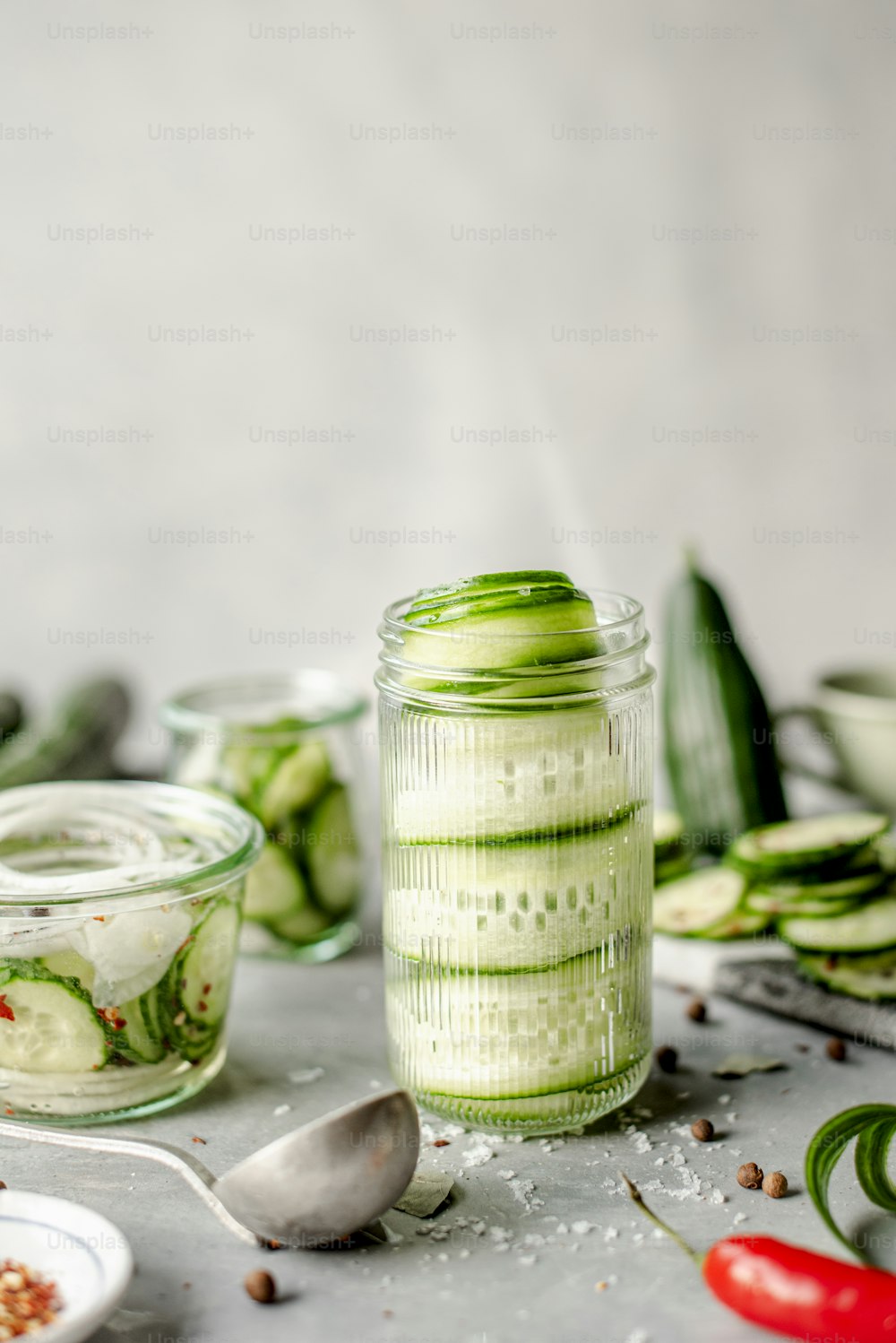a jar of cucumbers sits on a table