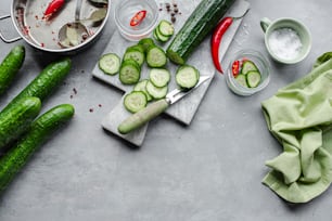 a bunch of cucumbers are on a cutting board