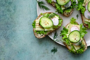 a white plate topped with cucumbers and lettuce