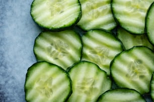 a pile of cucumber slices sitting on top of a table