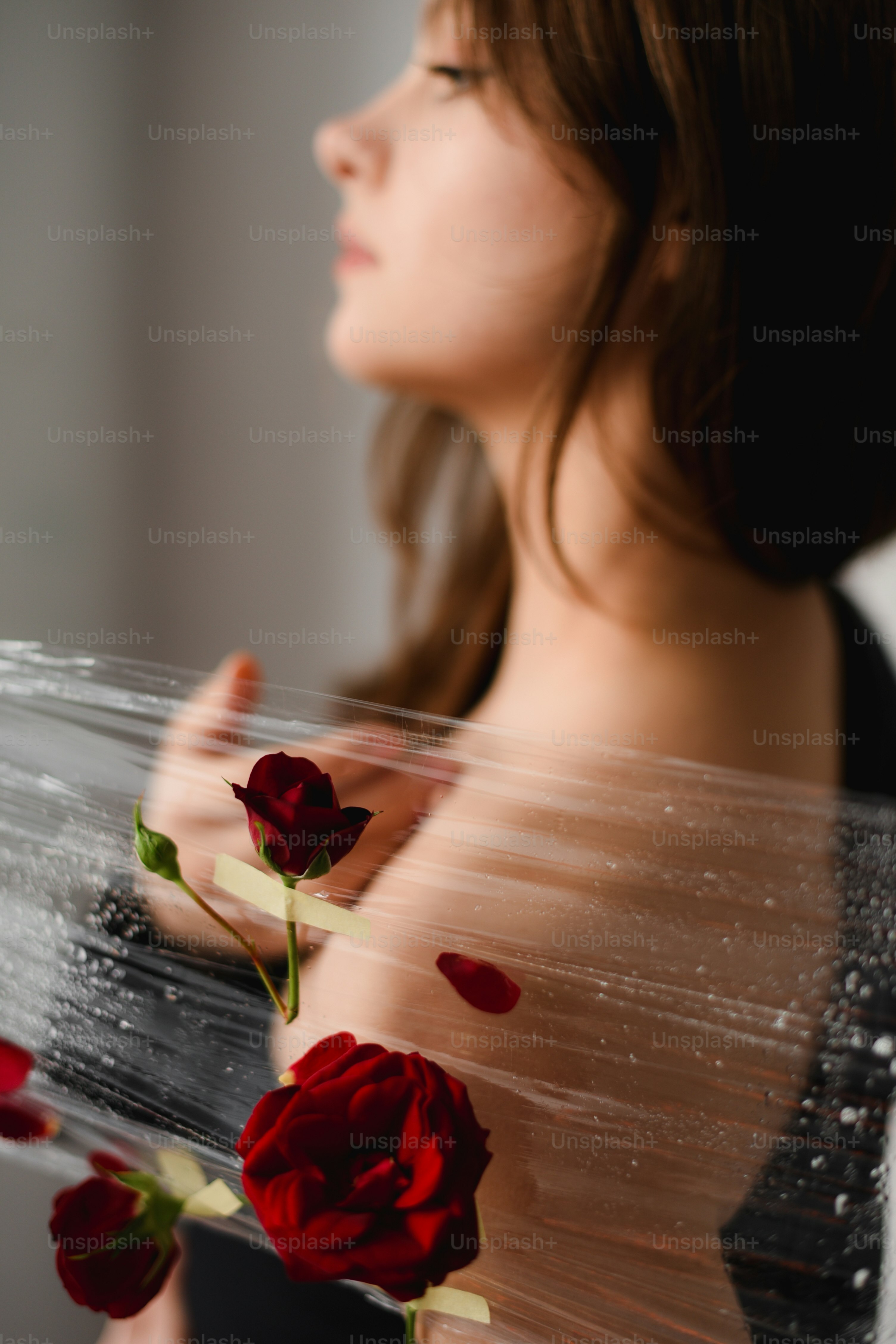 A woman holding a rose up to her face photo – Flower Image on Unsplash