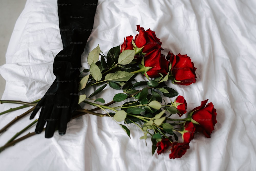 a bunch of roses that are laying on a bed