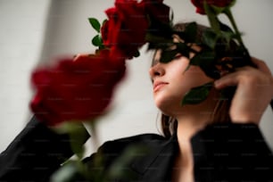 a woman holding roses up to her face