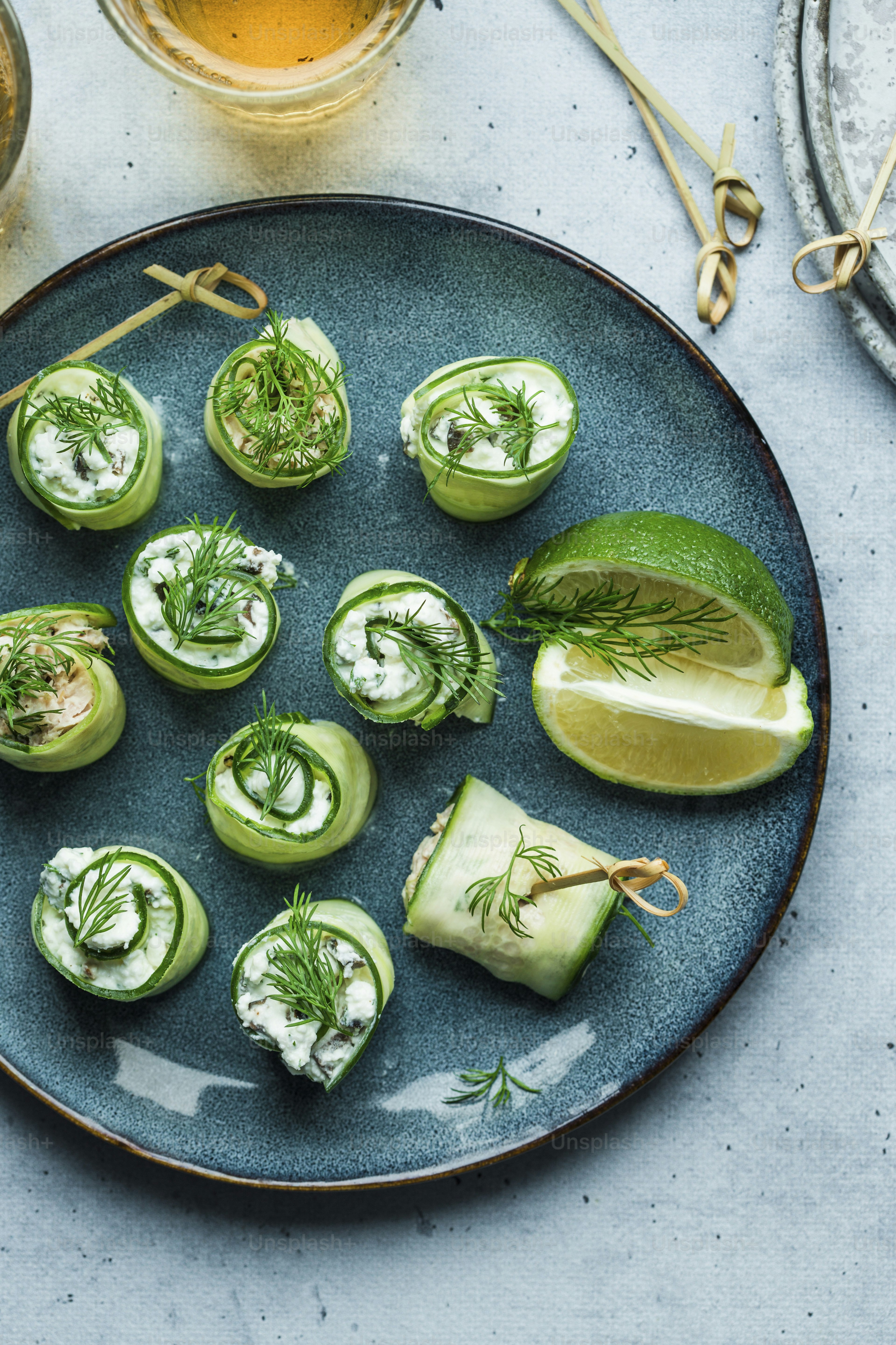 a blue plate topped with cucumbers covered in cream