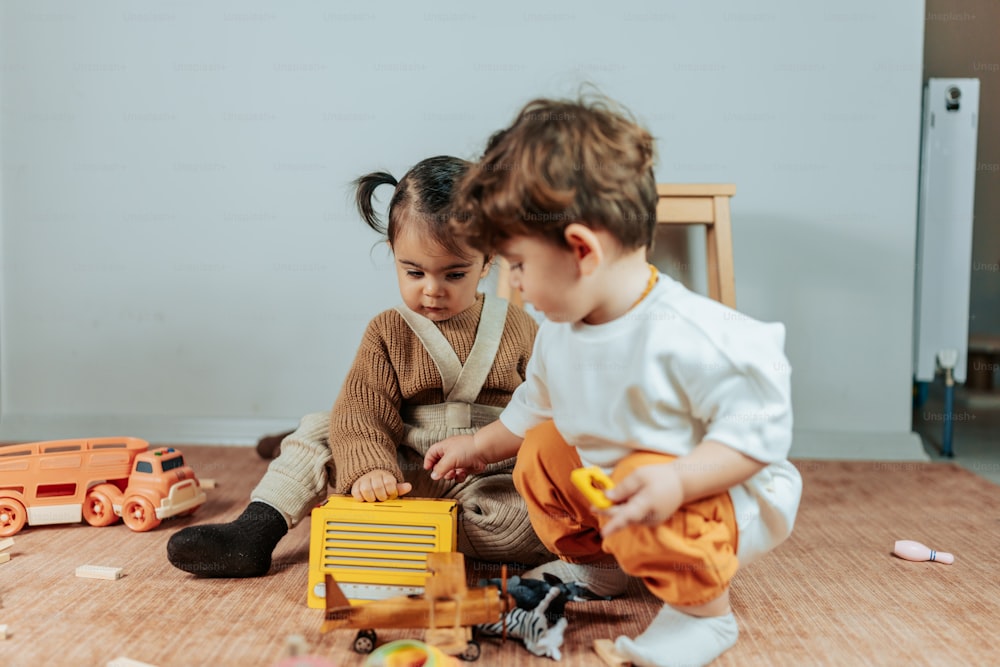 two children playing with toys on the floor