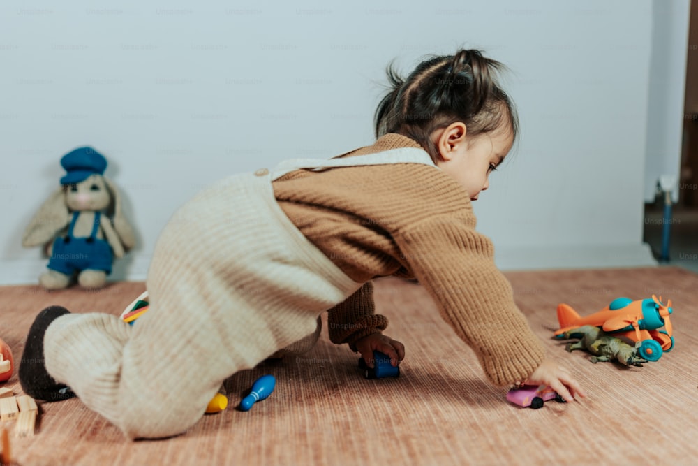 a baby crawling on the floor playing with toys
