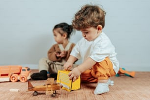 two children playing with toys on the floor