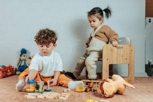 zwei Kinder spielen mit Spielzeug auf dem Boden