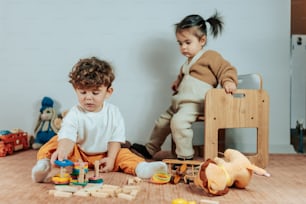 two children playing with toys on the floor