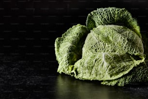 a pile of green cabbage sitting on top of a table