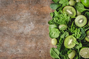 a bunch of green fruits on a wooden table