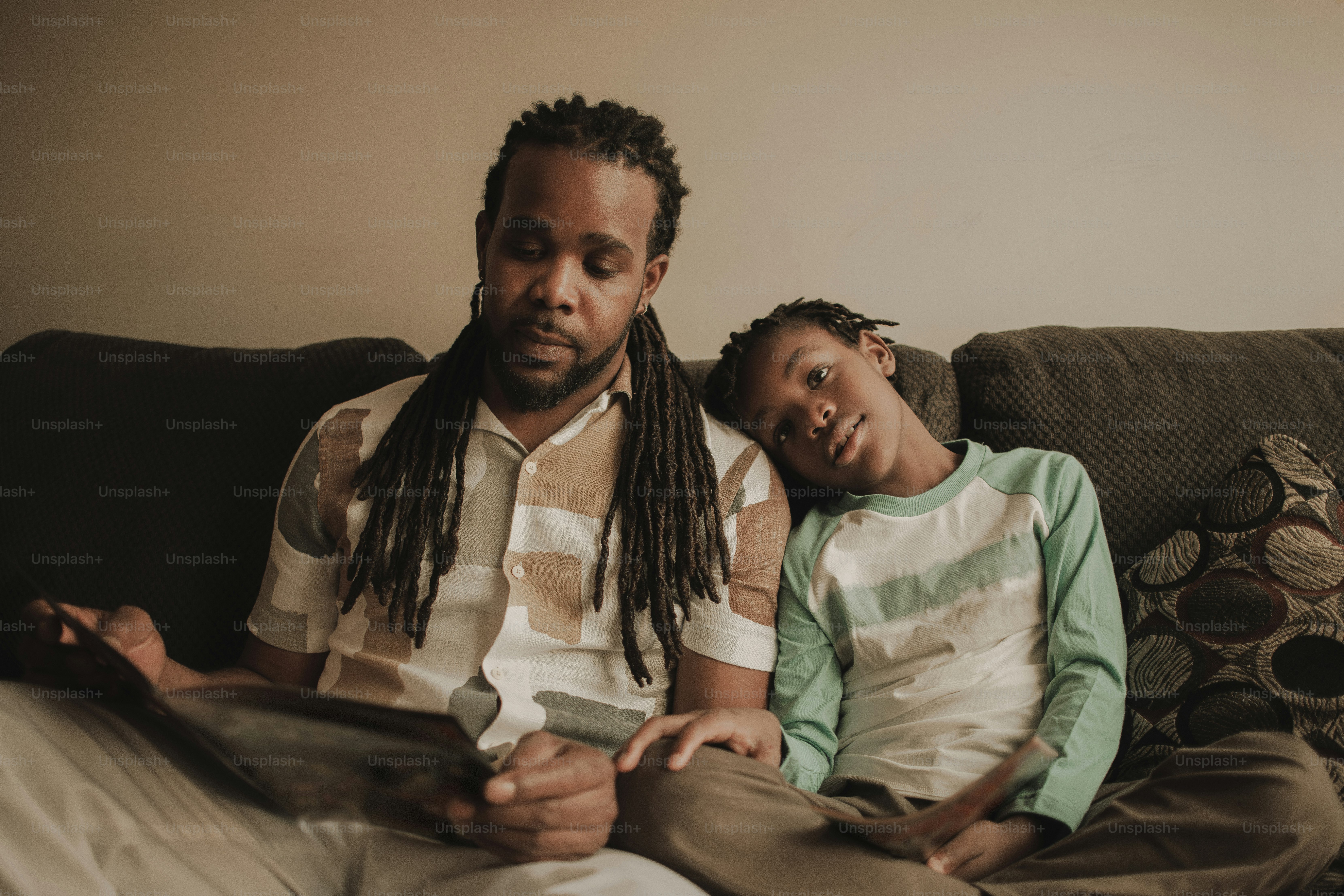 a man and a child sitting on a couch