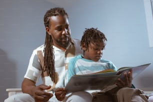 a man reading a book to a child