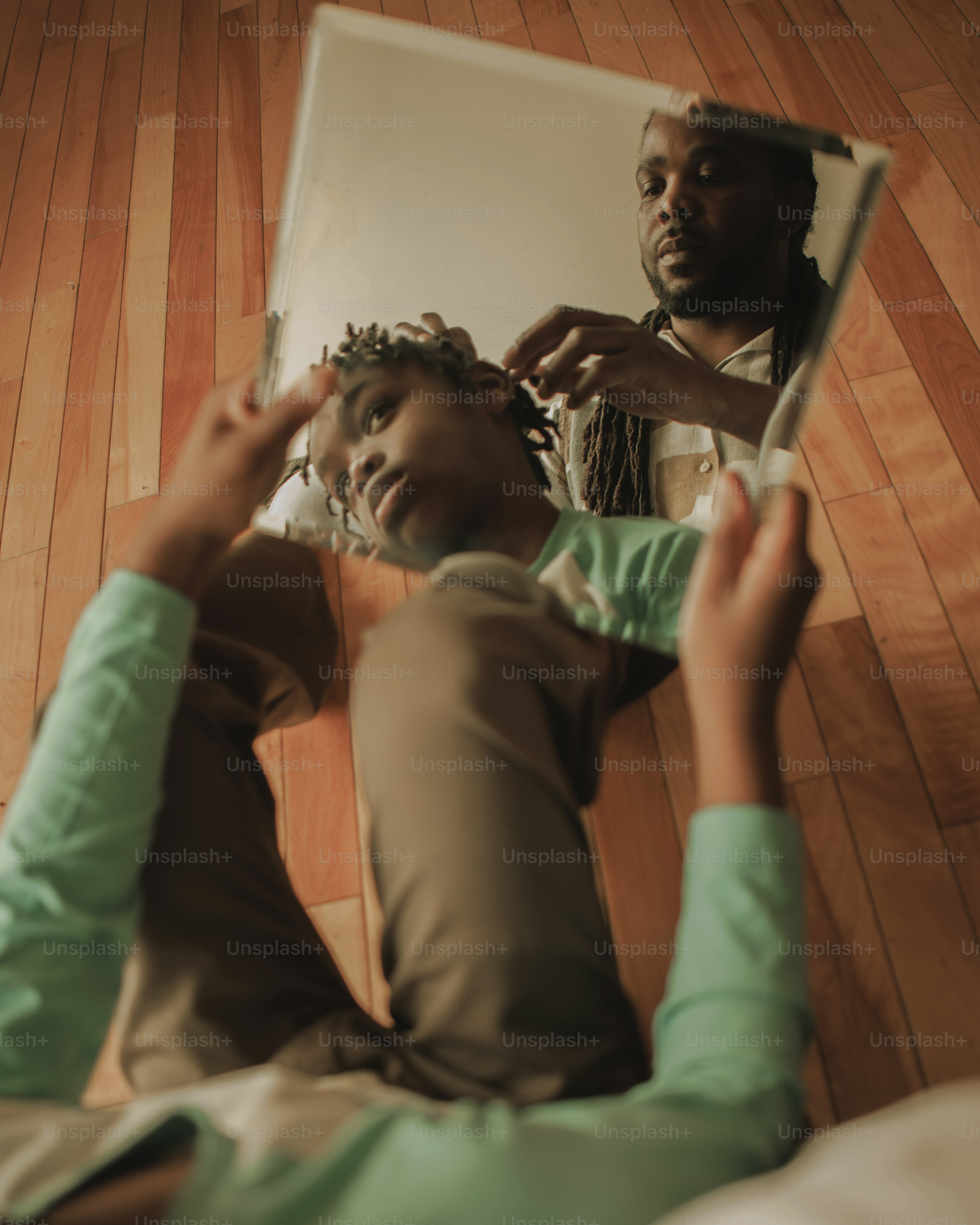 a man is brushing his hair in front of a mirror