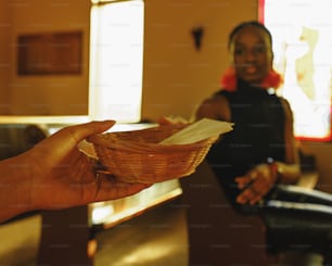 a person holding a basket with a piece of paper in it