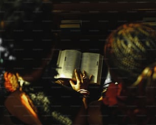 two women are reading a book together