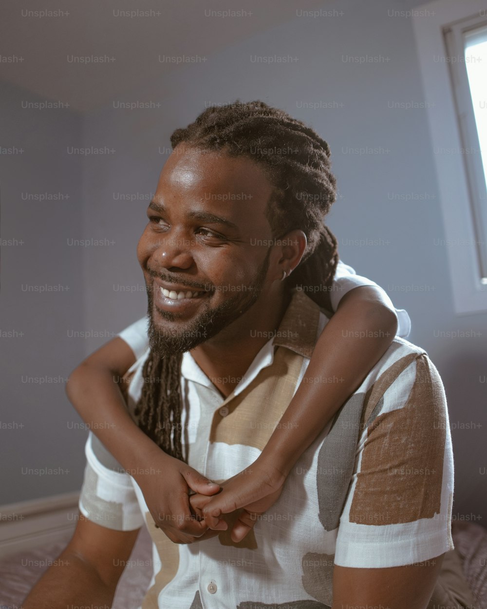 a man holding a child on his shoulders