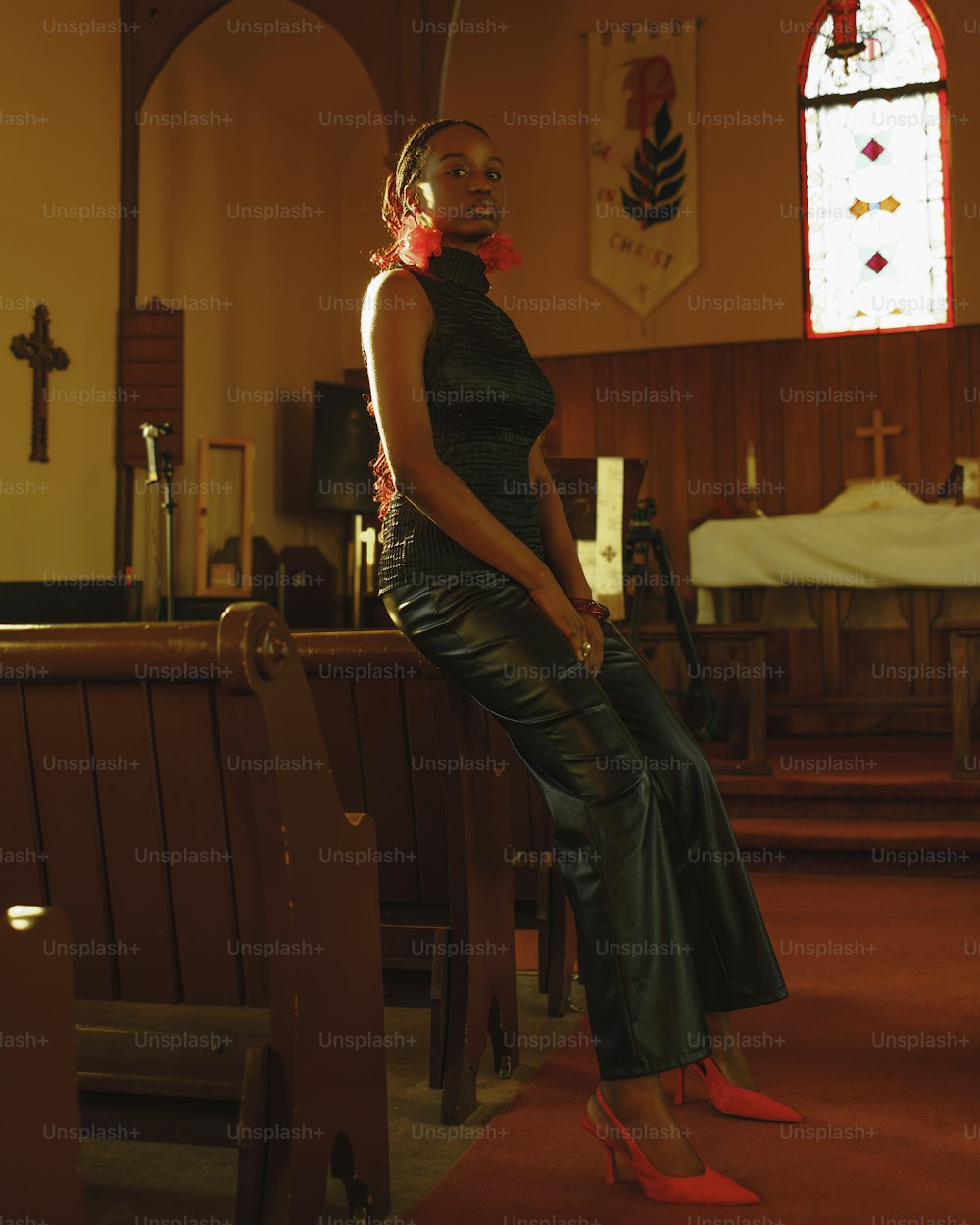 a woman sitting on a pew in a church