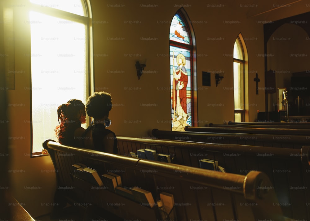 a couple of people that are sitting in a church