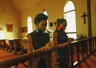 a couple of women standing next to each other in a church